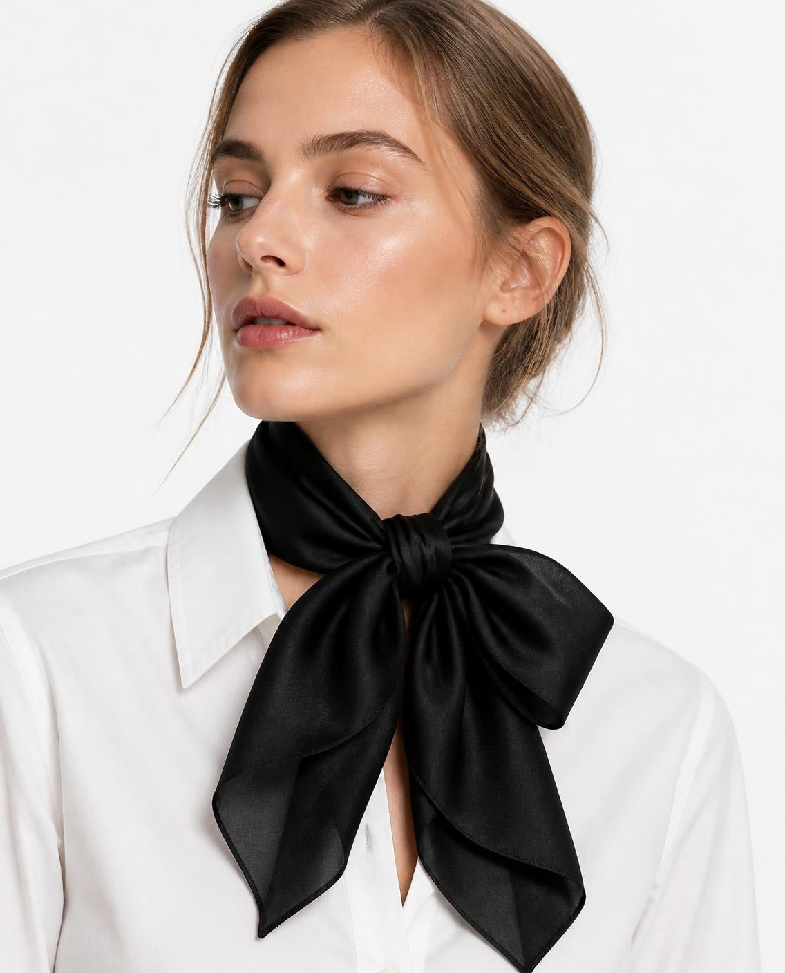 Model wearing the Noir silk scarf tied as a bow